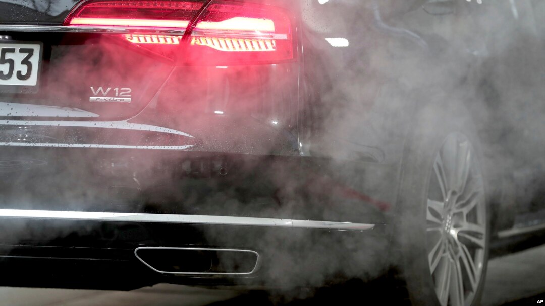In this file photo, a luxury Audi car is surrounded by exhaust gases as it is parked with a running engine in front of the Chancellery in Berlin, Germany, Wednesday, Nov. 20, 2019. (AP Photo/Michael Sohn, File)
