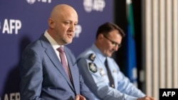 FILE - A handout photo taken on July 12, 2024, and received from the Australian Federal Police shows Australia's Director-General of Security and head of the Australian Security Intelligence Organization Mike Burgess, left, at a news conference in Canberra. 