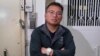 FILE - Ronson Chan, chair of the Hong Kong Journalist Association, posing outside the office of his former employer Stand News, which was shut down after police raided their offices and arrested seven people in Hong Kong, Jan. 7, 2022.