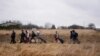 People walk with their belongings, as they flee Ukraine, at the border crossing in Medyka, Poland, March 5, 2022. 