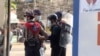 In this image made from video taken on Feb. 27, 2021, Associated Press journalist Thein Zaw is arrested by police in Yangon, Myanmar. Authorities charged Thein Zaw and other members of the media with violating a public order law.