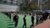 Residents line up to get tested for the coronavirus at a temporary testing center for COVID-19 in Hong Kong, Feb. 11, 2022.