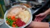 Volunteers prepare individual Thanksgiving meals for seniors in Hawthorne, N.J., on Nov. 3, 2020. With a fall surge of coronavirus infections gripping the US, many Americans are forgoing tradition and getting creative with celebrations.