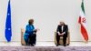European Union foreign policy chief Catherine Ashton (L) speaks with Iranian Foreign Minister Mohammad Javad Zarif before the start of two days of closed-door nuclear talks at the United Nations offices in Geneva, Oct. 15, 2013.