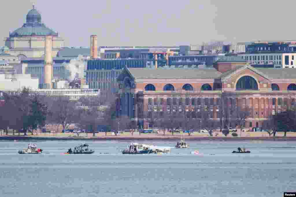 Search and rescue teams work in the aftermath of the collision of American Eagle flight 5342 and a Black Hawk helicopter that crashed into the Potomac River, as seen from the U.S. city of Alexandria, Virginia, January 30, 2025.