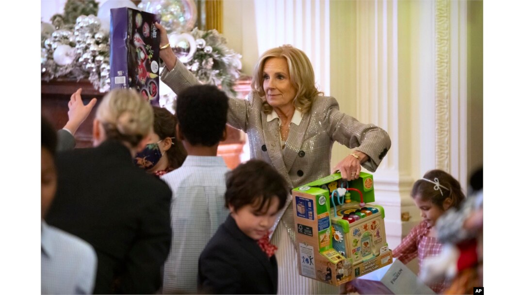 First lady Jill Biden helps sort toys as she hosts a Toys for Tots event with Marine Corps families in the East Room at the White House in Washington, Dec. 13, 2024.