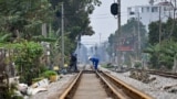 This photo taken on February 13, 2025 shows workers at a railway crossing in Hanoi.