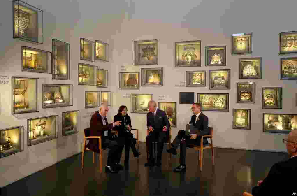 Britain's Prince Charles, second right, speaks with Holocaust survivor Marta Wise, second left, and George Shefi, left, whose mother perished at Auschwitz, during a reception at the Israel Museum in Jerusalem.