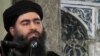 This file image made from video posted on a militant website in July 2014, which has been authenticated based on its contents and other AP reporting, purports to show Abu Bakr al-Baghdadi, the leader of the Islamic State group, delivering a sermon at a mosque in Mosul, Iraq. 