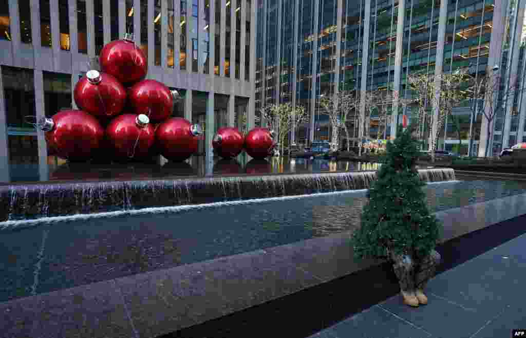 Street performer Thomas Liberto from Bel Air, Maryland, who goes by the social media name &quot;Mr. Christmas Tree,&quot; sits by Christmas decorations around midtown New York, Dec. 19, 2019.