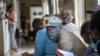 Volunteers wait to be checked at a vaccine trial facility set at Soweto's Chris Sani Baragwanath Hospital outside Johannesburg, South Africa, Nov. 30, 2020. 