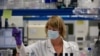 FILE - A lab technician works during research on coronavirus at Johnson & Johnson subsidiary Janssen Pharmaceutical in Beerse, Belgium, June 17, 2020. 