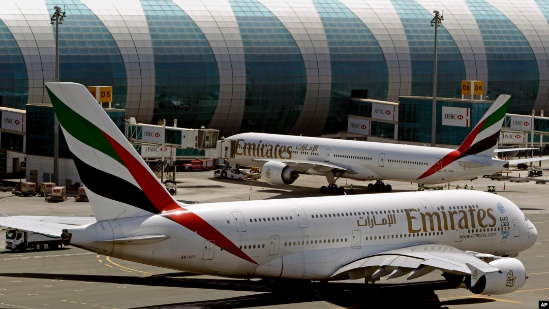 FILE - This May 8, 2014 file photo shows Emirates passenger planes at Dubai airport in United Arab Emirates. The U.S. government is temporarily barring passengers on certain flights originating in eight other countries from bringing most types of electronics in their carry-on luggage. (AP Photo/Kamran Jebreili, File)