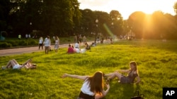 People enjoy the warm weather at Gorky Park during sunset in Moscow, Russia, June 7, 2020, as the authorities have eased the tight lockdown restrictions introduced in late March, due to the outbreak of coronavirus.