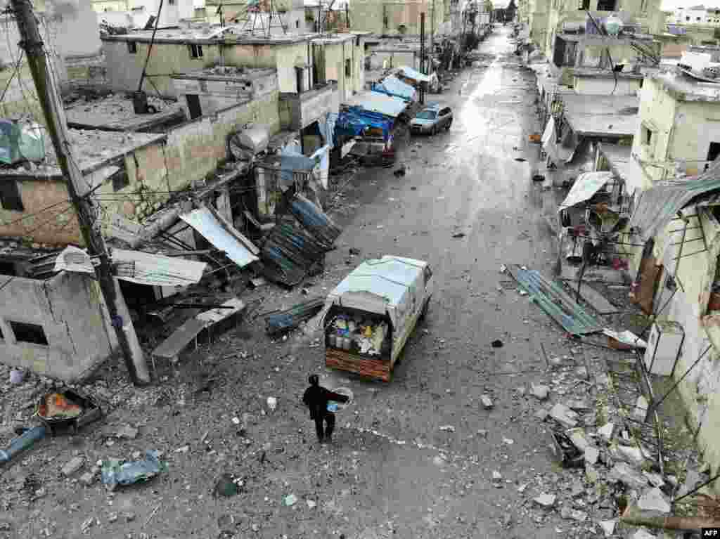 A Syrian who fled from the town of Sarmin, about 8 kilometers southeast of Idlib in northwestern Syria, returns to the town as it is partially surrounded by government forces to collect some belongings amidst a period of calm.