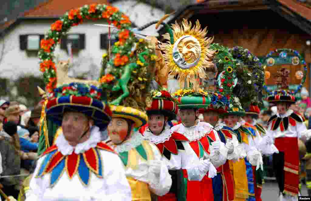 Participants dressed as Schleicher attend the traditional Schleicherlaufen run during Shrovetide (Fasnacht) in Telfs, Austria.