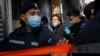 FILE - Daniel Wong Kwok-tung, a lawyer who tried to help the 12 people detained in mainland China, is escorted by police as he returns to his office in Hong Kong, China, Jan. 14, 2021.