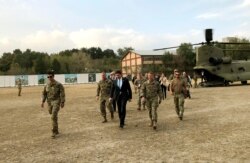 U.S. Defense Secretary Mark Esper, center, walks Gen. Scott Miller, right, chief of the U.S.-led coalition in Afghanistan, at the U.S. military headquarters in Kabul, Afghanistan, Sunday, Oct. 20, 2019.
