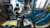 FILE - An employee works at the printing facility of the Apple Daily newspaper in Hong Kong, May 11, 2021.