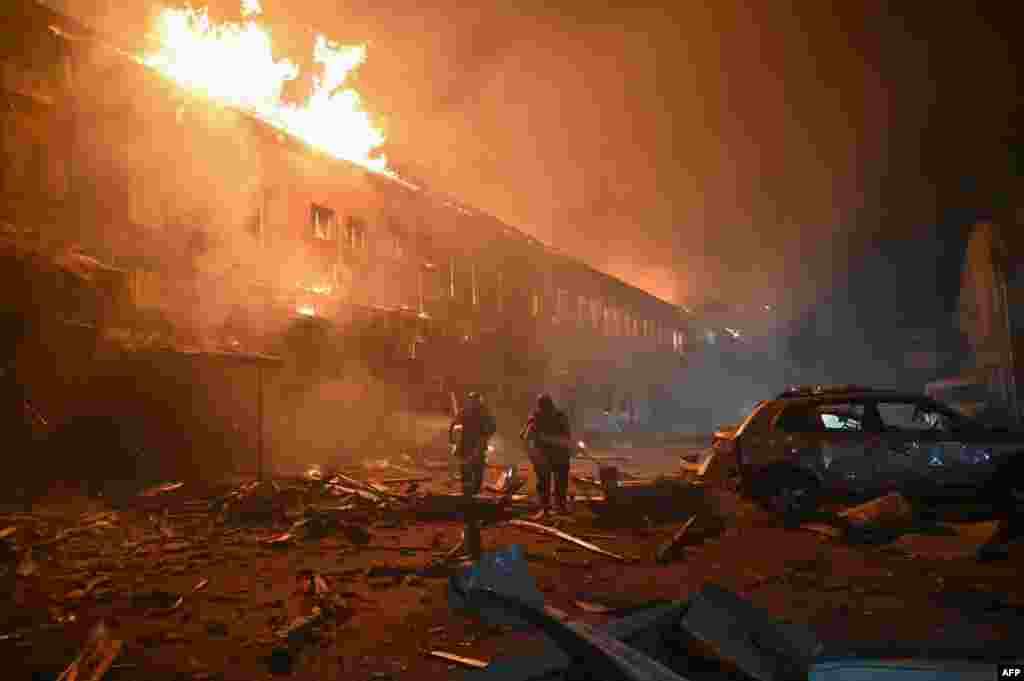 Rescuers of the State Emergency Service work to put out a fire in a building after a drone strike in Kharkiv amid the Russian invasion in Ukraine.