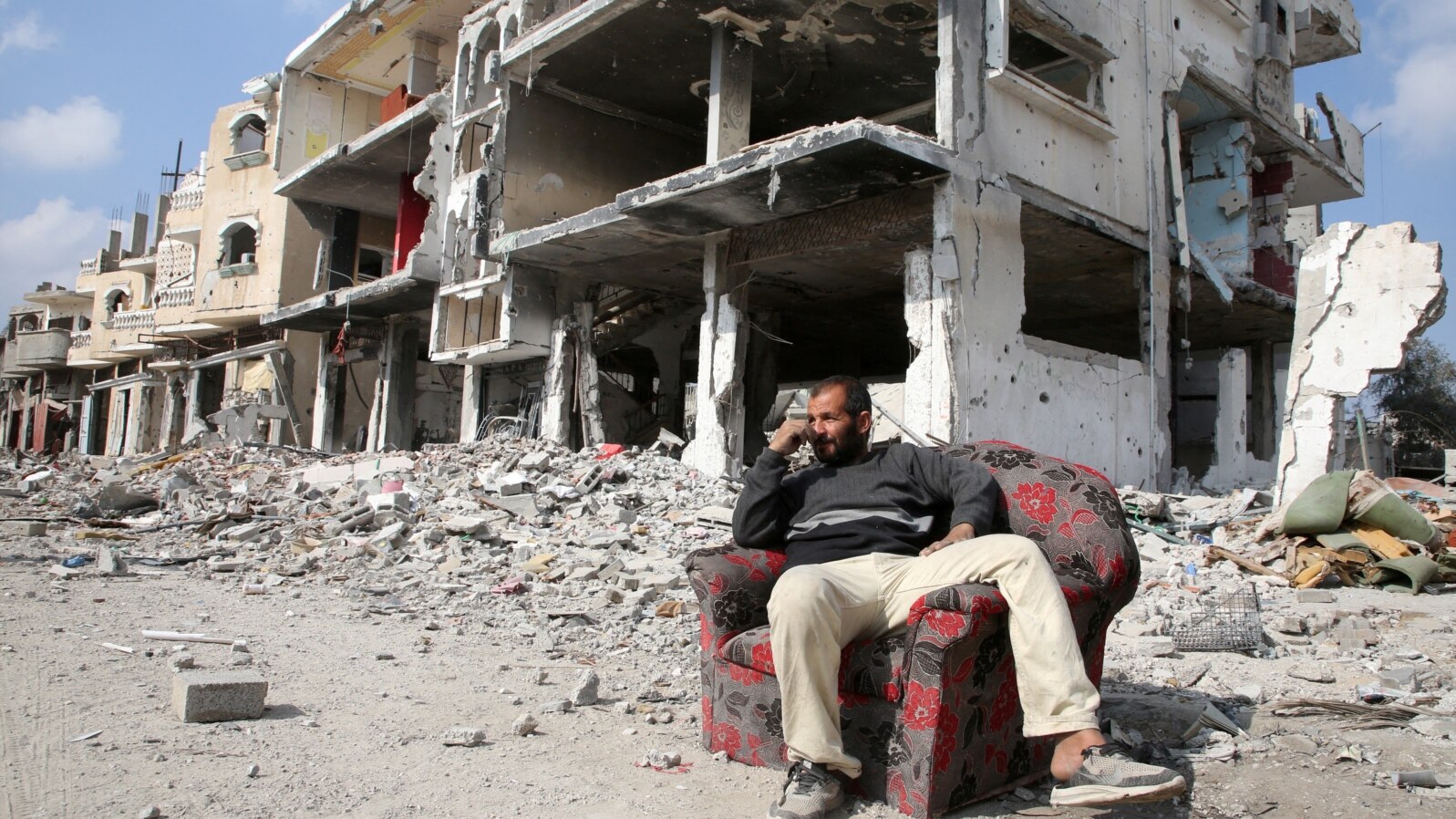 A Palestinian sits among the rubble of buildings destroyed during the Israeli offensive, amid a ceasefire between Israel and Hamas, in Rafah in the southern Gaza Strip, Feb. 4, 2025. 