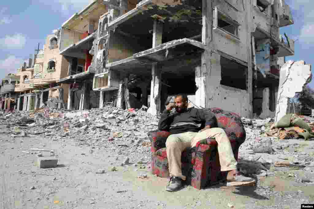 A Palestinian sits among the ruins of buildings destroyed during the Israeli offensive in Rafah in the southern Gaza Strip, on February 4, 2025.