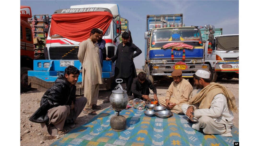Drivers of Afghanistan-bound trucks wait for the opening of Pakistan Afghanistan border outside Peshawar, Pakistan, March 14, 2017.