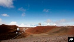 FILE - Observatories and telescopes sit atop Mauna Kea, Hawaii's tallest mountain and designated construction site for a new $1.4 billion telescope, near Hilo, Hawaii, Aug. 31, 2015. 