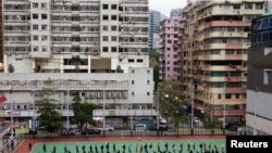 People line up at a makeshift testing site for the coronavirus disease (COVID-19), following the outbreak in Hong Kong, China on Feb. 18, 2022.