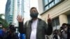 Pro-democracy activist Lee Cheuk-yan gestures before his sentencing in Hong Kong, April 16, 2021. A court sentenced five leading pro-democracy advocates to up to 18 months in prison for organizing a march during the 2019 anti-government protests.
