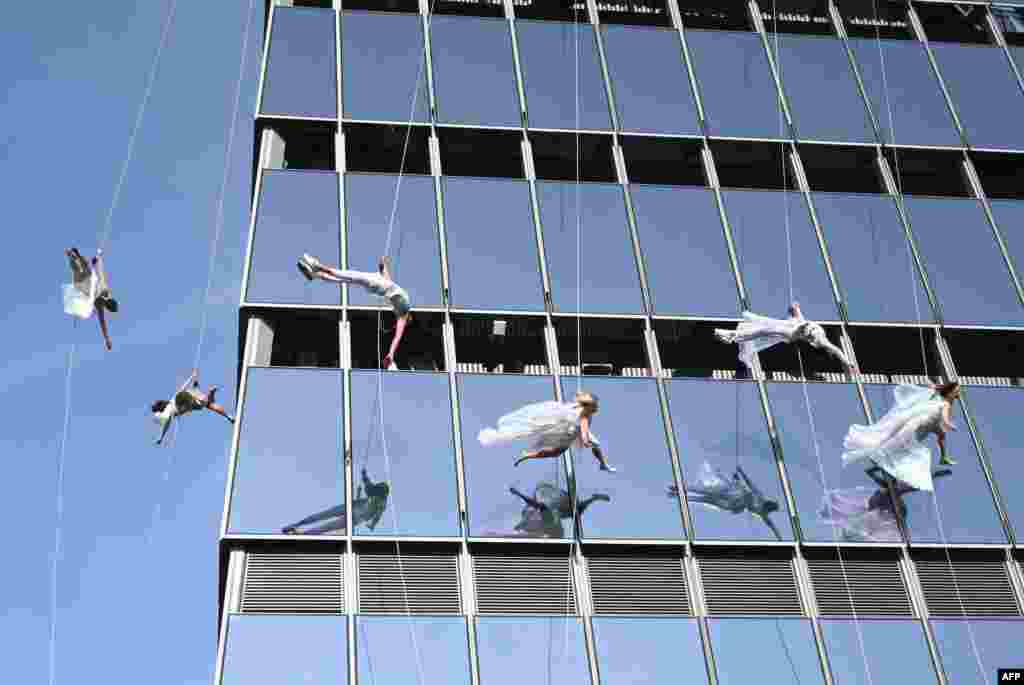 Vertical performers "BANDALOOP" perform at the opening of "Edge," the Western Hemisphere's highest outdoor sky deck in New York City. "Edge" offers 360-degree views of New York City's iconic skyline, rising 1,131 feet in the air from the heart of Hudson Yards, located on the 100th floor.