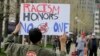 Josh Hunt protests as fans walk to the ballpark before a baseball game, Tuesday between the Chicago White Sox and the Cleveland Indians, April 11, 2017, during opening day in Cleveland. Hunt is from the Cheyenne and Arapaho Tribe