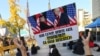 FILE - A protester tosses a banner showing a photo of U.S. President Donald Trump and North Korean leader Kim Jong Un during a rally against the United States' policy to put steady pressure on North Korea near the U.S. Embassy in Seoul, South Korea, Nov. 3, 2018.