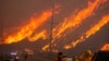 Members of a firefighting crew work to battle the Hughes Fire near Castaic Lake, north of Santa Clarita, California, Jan. 22, 2025. 