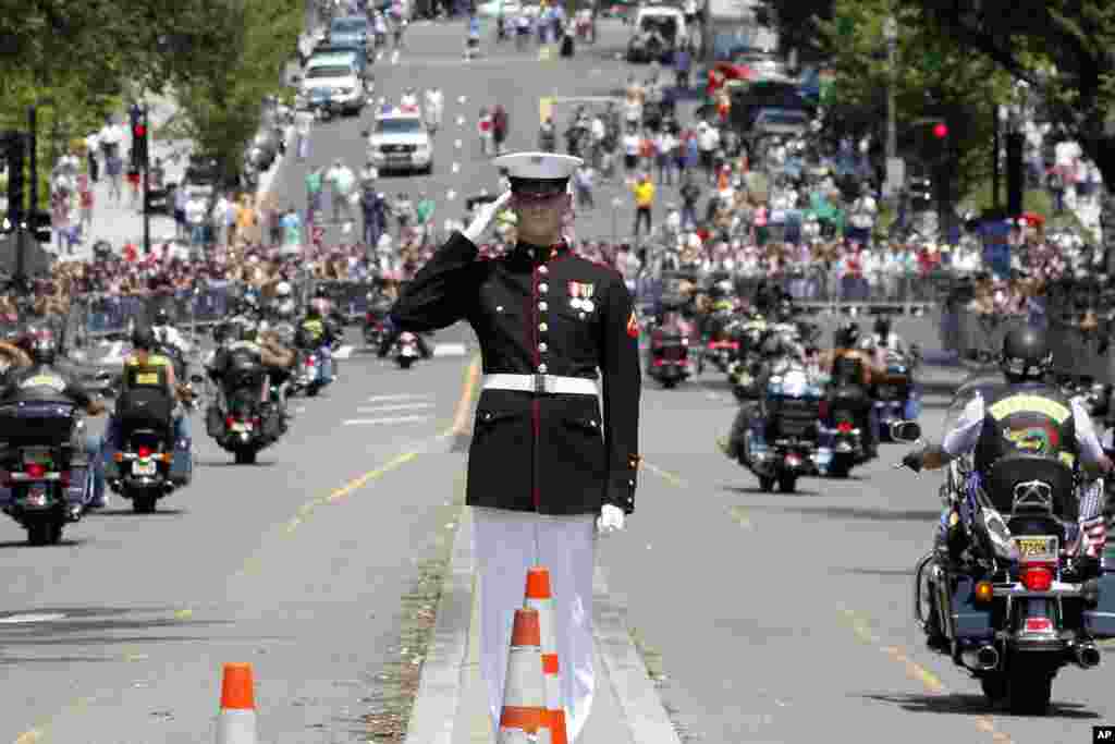 A Marine salutes as motorcycles drive past during the annual Rolling Thunder parade ahead of Memorial Day in Washington, May 27, 2012.