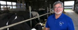 Dave Daniels stands on his farm in Union Grove, Wis., Aug. 6, 2019. He says the trade war so far hasn't affected his support for President Trump, but "We'll see what happens in the next few months."