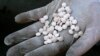 A Bulgarian customs officer displays Captagon pills confiscated in Sofia, Dec. 12, 2007. 
