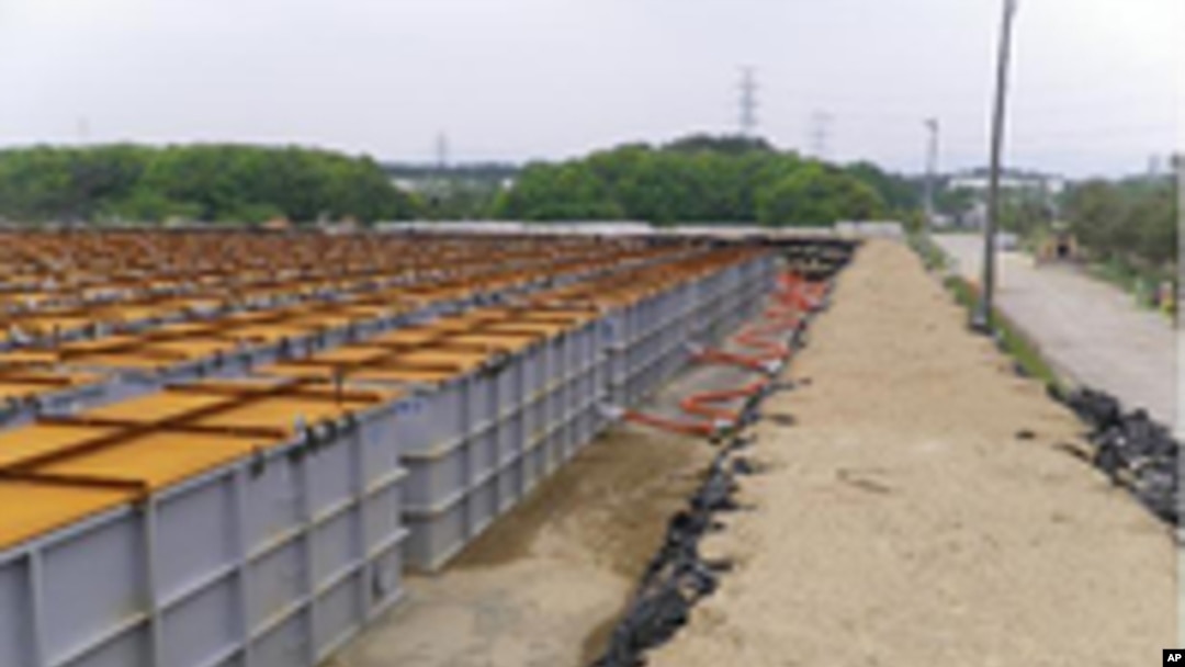 Temporary storage tanks for low and middle level radioactive water from Tokyo Electric Power (TEPCO) Co.'s Fukushima Daiichi Nuclear Power Station's No.1, No.2, No.3 and No.4 reactors are seen at the grounds of the plant in Fukushima prefecture, June 5, 2