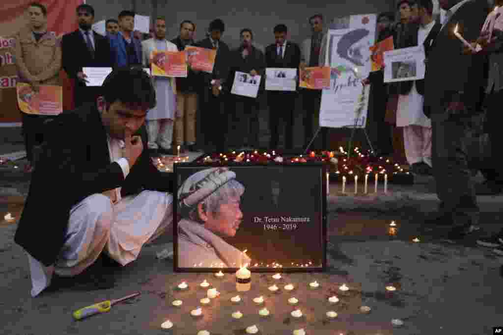 Afghans attend a candlelight vigil in Kabul in memory of Tetsu Nakamura, a Japanese physician who was killed in an attack in Jalalabad.