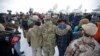 Members of the group occupying the Malheur National Wildlife Refuge headquarters hug after Ammon Bundy, center, left, one of the sons of Nevada rancher Cliven Bundy, spoke with reporters during a news conference Monday, Jan. 4, 2016, near Burns, Oregon.