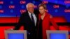 U.S. Senators Bernie Sanders (l) and Elizabeth Warren speak on the first night of the second 2020 Democratic presidential debate in Detroit, Michigan, July 30, 2019.