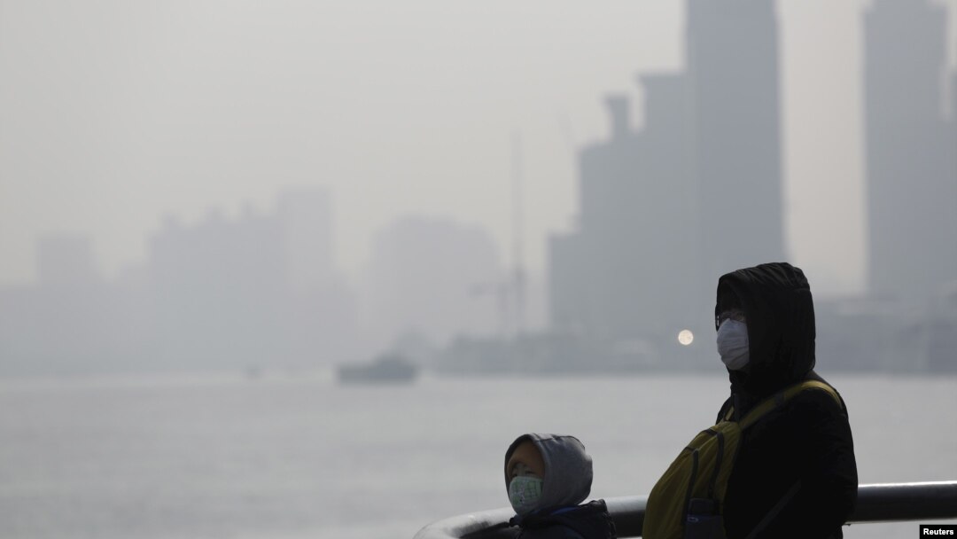 中國霧霾嚴重，1月19日在上海一名市民戴上口罩。