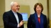 EU foreign policy chief Catherine Ashton (R) arrives with Iranian Foreign Minister Mohammad Javad Zarif before the start of three days of closed-door nuclear talks at the U.N. European headquarters in Geneva, Nov. 20, 2013