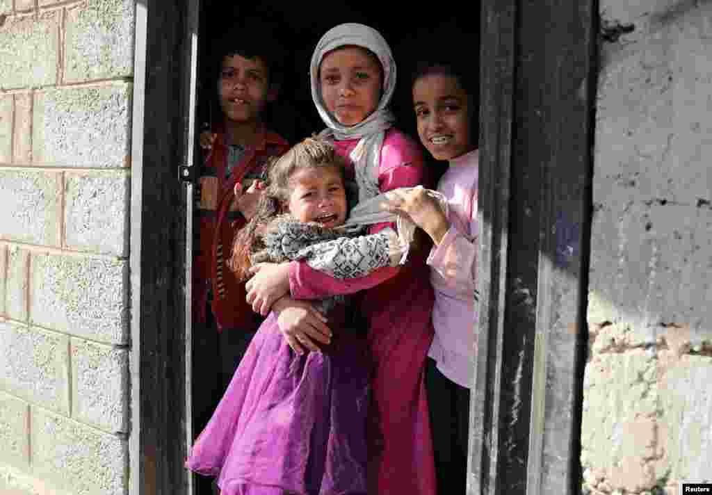A girl reacts after she was administered with polio vaccine during a house-to-house vaccination campaign in Sana'a, Yemen, Dec. 25, 2019.