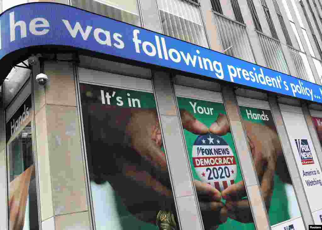 Headlines from the testimony of U.S. Ambassador to the European Union Gordon Sondland to a House Intelligence Committee hearing as part of the impeachment inquiry into President Donald Trump are seen on a news display outside Fox News headquarters in New York.