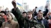 People cheer as they listen to speeches in front of a statue in Independence Square in Kyiv, Feb. 21, 2014.