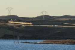 Dakota Access Pipeline equipment is seen near Lake Oahe, near the Standing Rock Indian Reservation, in this picture taken from across the Missouri River in Linton, North Dakota, Nov. 9, 2016.