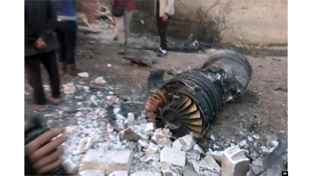 A photo provided by the Ibaa News Agency, the media arm of al-Qaida’s branch in Syria, reportedly shows part of a Russian jet that was shot down by rebel fighters over Idlib province in Syria, Feb. 3, 2018.