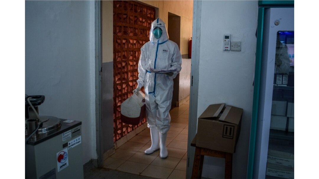 A technician carries samples from truck drivers testing for COVID-19 at the laboratory of Kenya Medical Research Institute (KEMRI) in Busia, a town bordering with Uganda in western Kenya, on May 14, 2020.