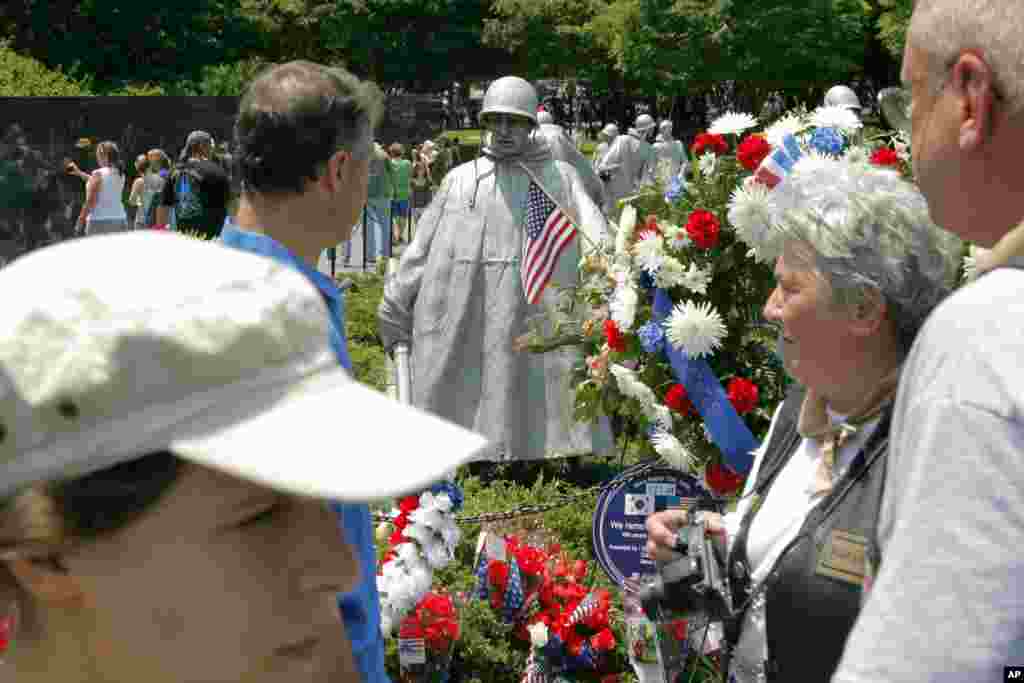 Visitors stop at the Korean War Veterans Memorial ahead of Memorial Day in Washington, May 27, 2012.